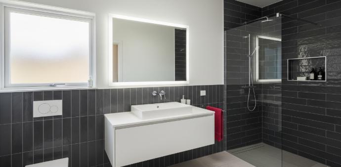 4x12 grey subway tiles installed in modern bathroom