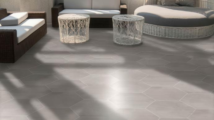 patio seating area with grey hexagonal stone look tile