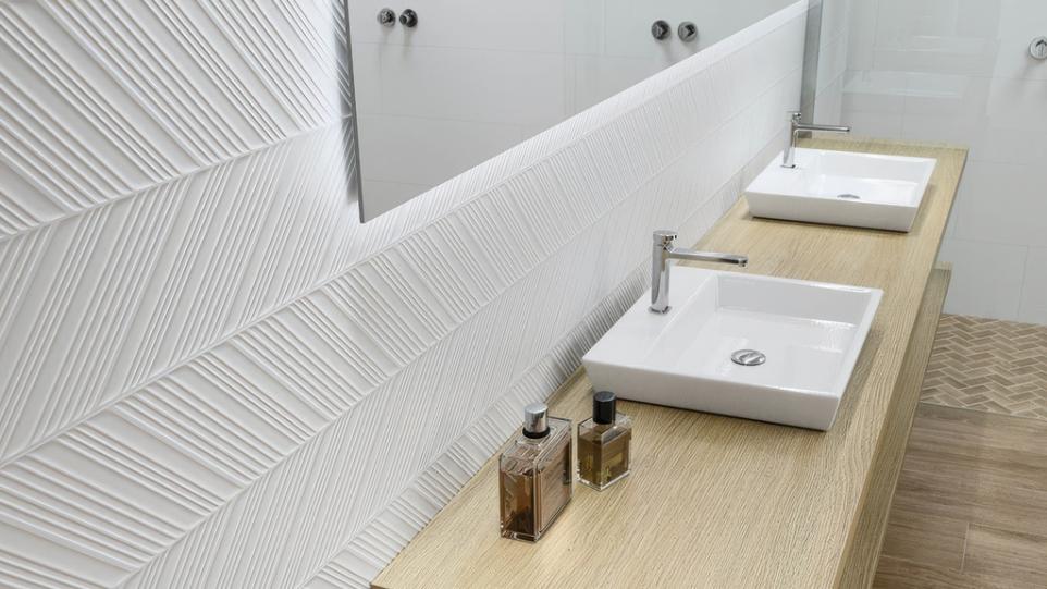 Double vanity with a modern wood counter and white sinks, highlighting the decorative white Prestige 12x24 Matte 3D Decorative Ceramic Wall Tile