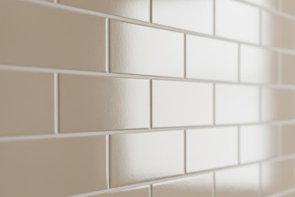 Close-up of beige subway tiles showing smooth porcelain surface texture and grout lines