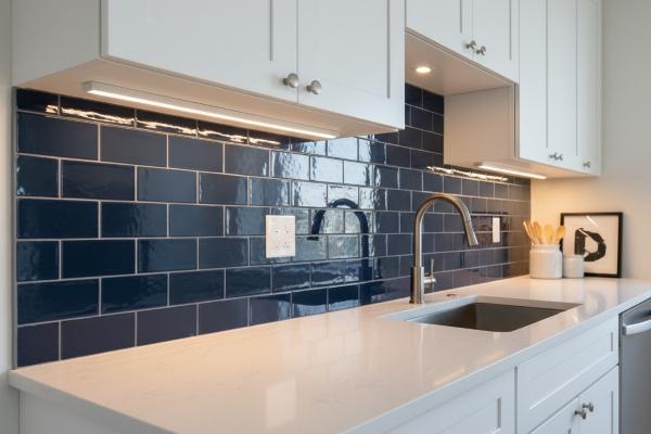 Blue porcelain subway tiles installed in modern kitchen backsplash
