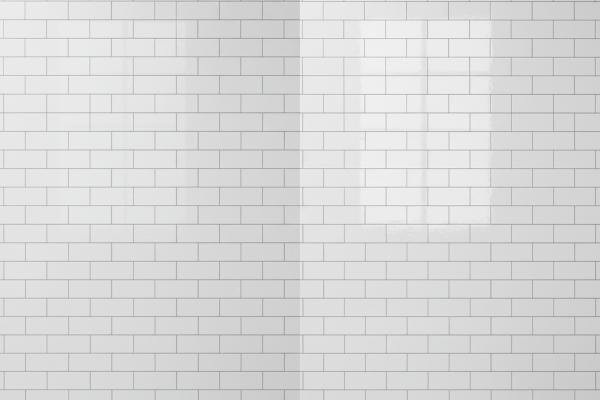 Side-by-side comparison of matte white subway tiles and glossy white subway tiles showing different light reflection