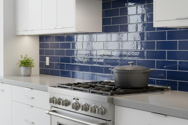 Blue glossy subway tiles installed as kitchen backsplash behind modern stove