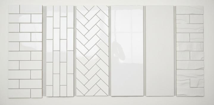 Six white subway tile samples displayed side-by-side, showing different installation patterns and finishes