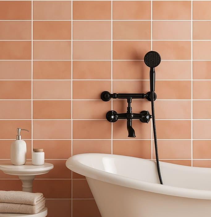 A bathroom wall decorated with terracotta-colored 3x6 subway tiles