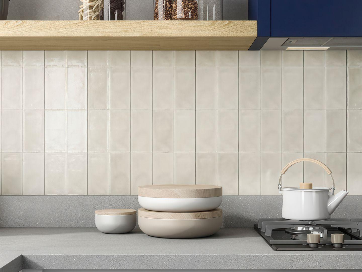 A kitchen backsplash featuring off-white 3x6 subway tiles stacked vertically