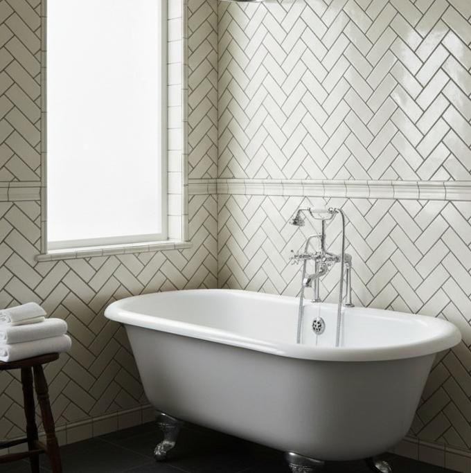 Herringbone pattern vintage subway tile installation in bathroom