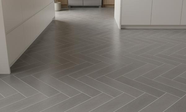 Herringbone subway tile backsplash in modern white kitchen with dark grout lines