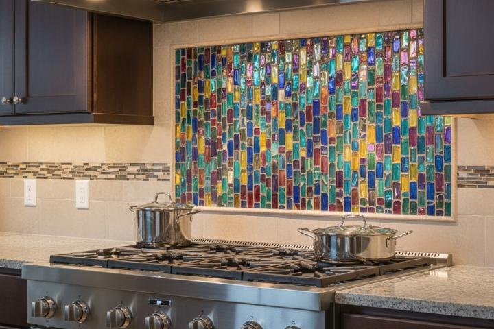 Colorful glass mosaic tile accent behind stainless steel range