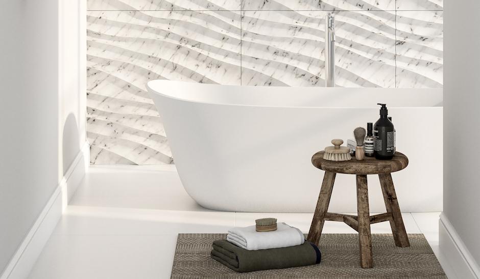 Modern freestanding bathtub with 3D wave textured white marble wall tiles