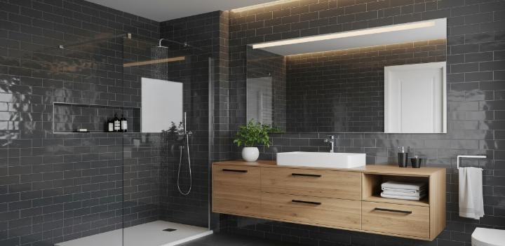 Sleek modern bathroom with gray glossy subway tiles, a floating wood vanity, and a glass shower.