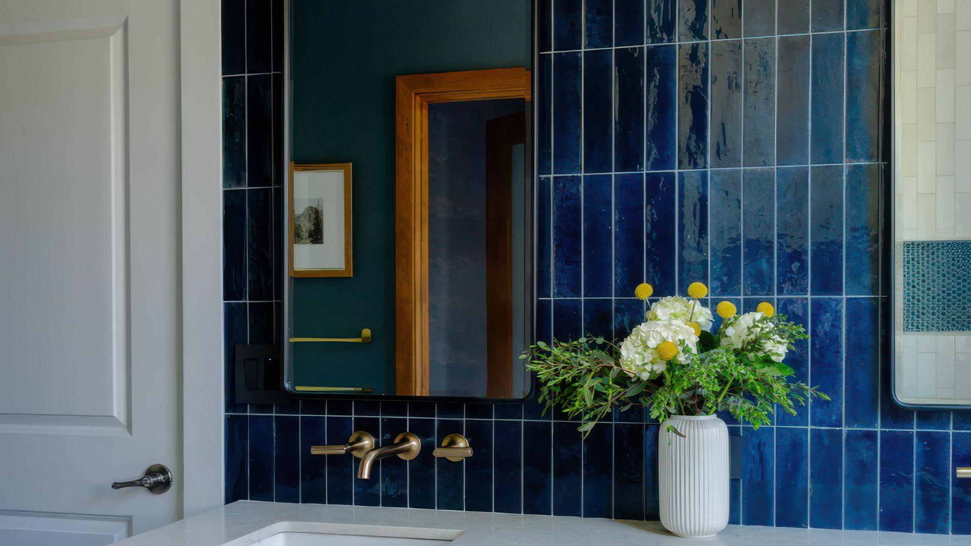 Blue subway tile bathroom with brass fixtures
