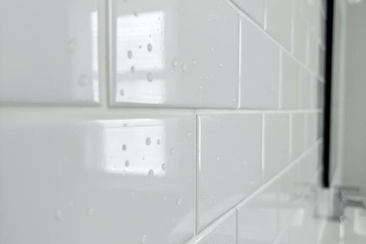Close-up of clean white grout lines in a modern subway tile pattern, sealed professionally