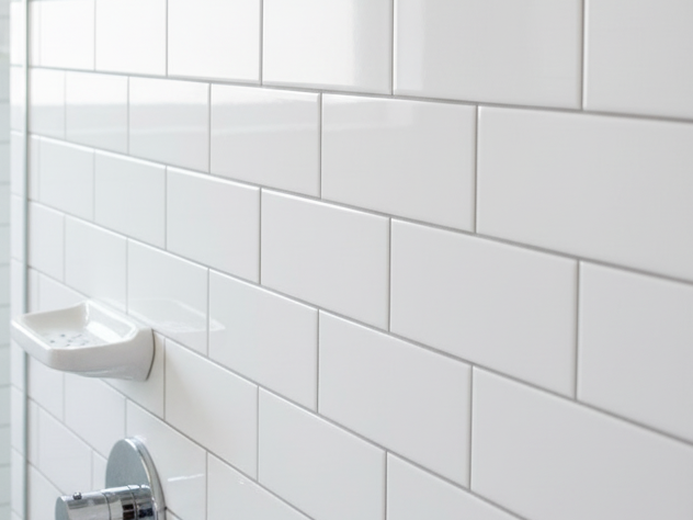 Close-up of reflective white 3x6 subway tile showing light-enhancing properties