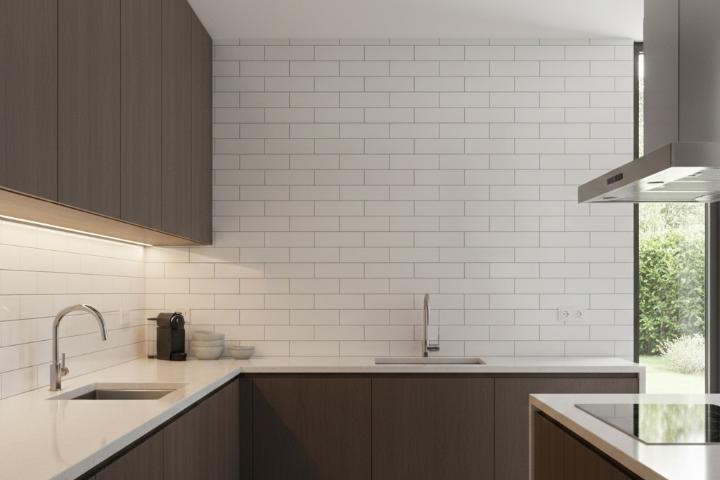 Full-height white subway tile kitchen backsplash extending to ceiling with modern cabinets