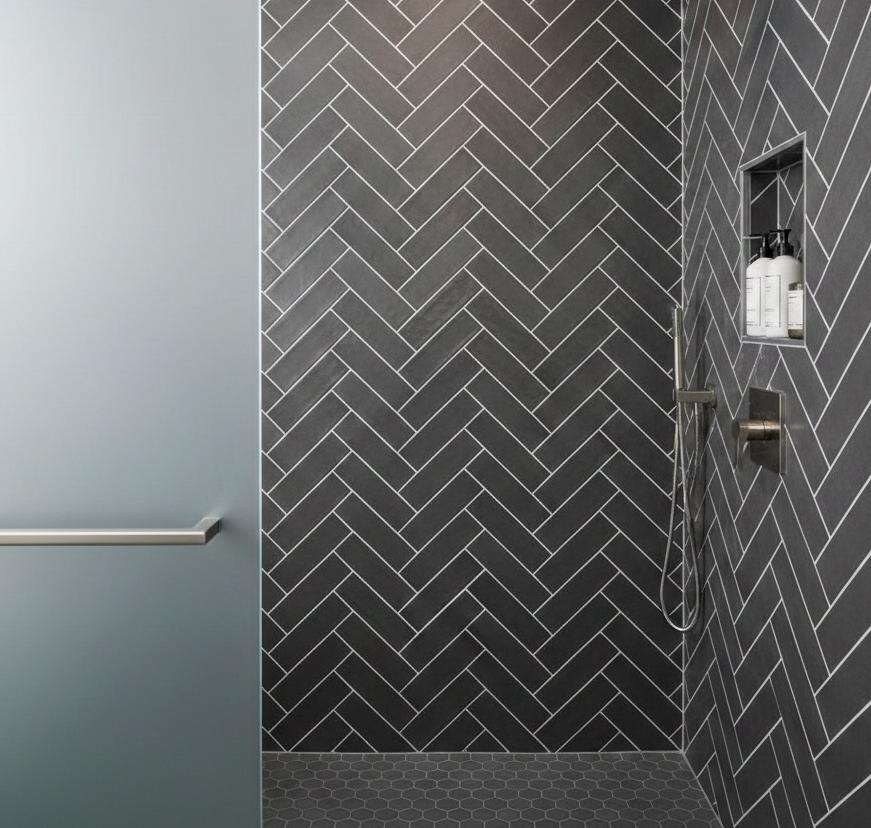 Matte finish 5x10 ceramic subway tile arranged in herringbone pattern with grey tiles and matching grout