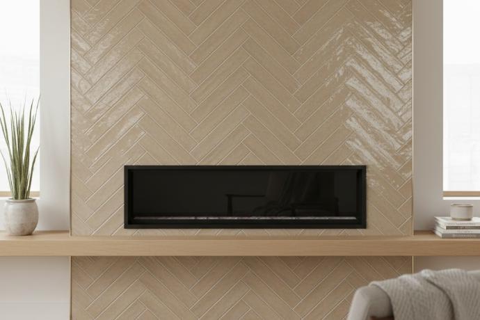 Herringbone pattern layout using elongated 2x6 glossy subway tile in neutral beige color on accent wall