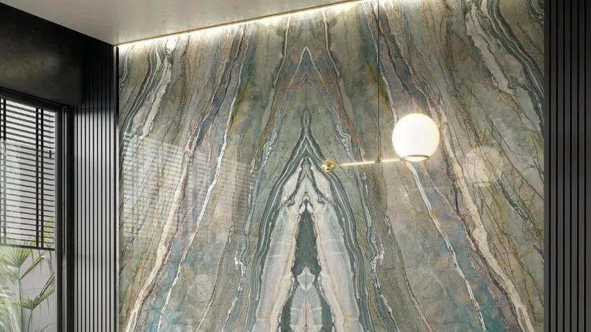 Dramatic wall installation using Royal Peacock porcelain slabs with mirrored veining and backlighting.