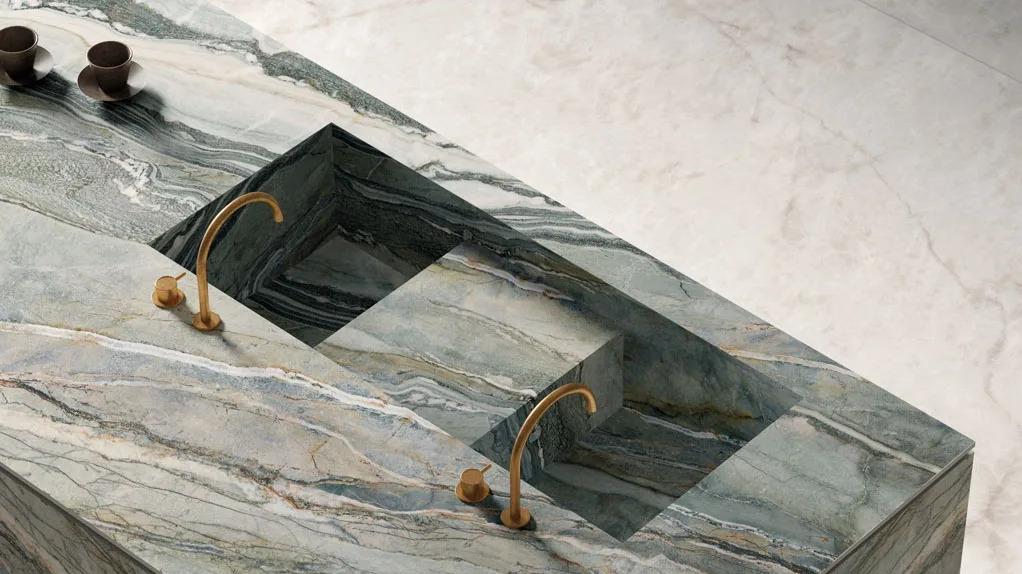 Styled accessories displayed on Royal Peacock porcelain slabs showcasing swirling marble-like veining details.