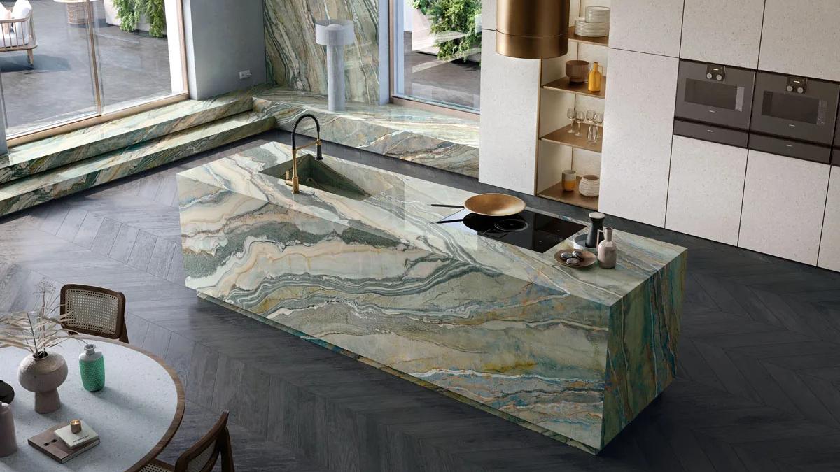 Waterfall edge kitchen design showcasing Royal Peacock porcelain slabs with flowing organic patterns.