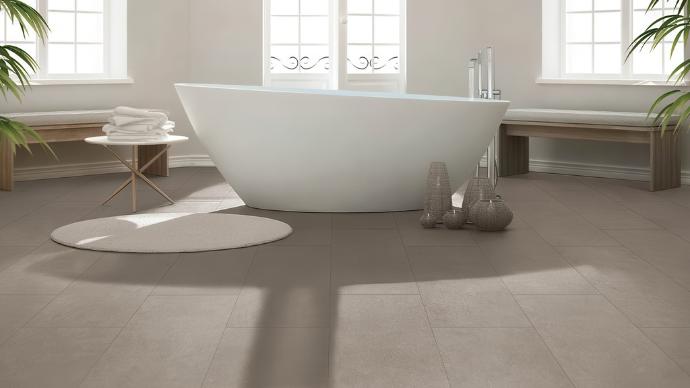 Freestanding bathtub on Influence 12x24 Matte Cement Look Porcelain Tile in a modern, minimalist bathroom.