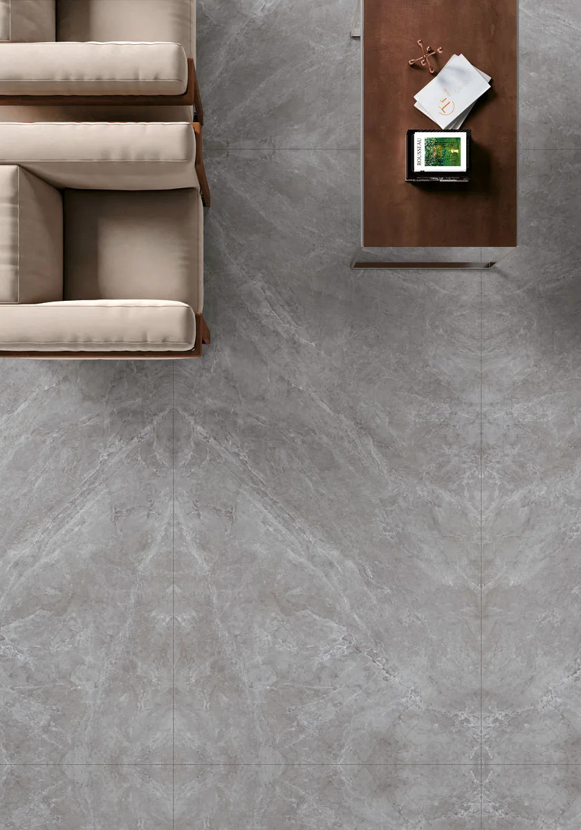 Tundra Select porcelain slabs installed as elegant grey flooring in contemporary living room setting.
