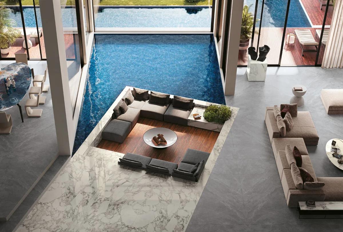 Tundra Select porcelain slabs in modern home with sunken lounge and pool views.