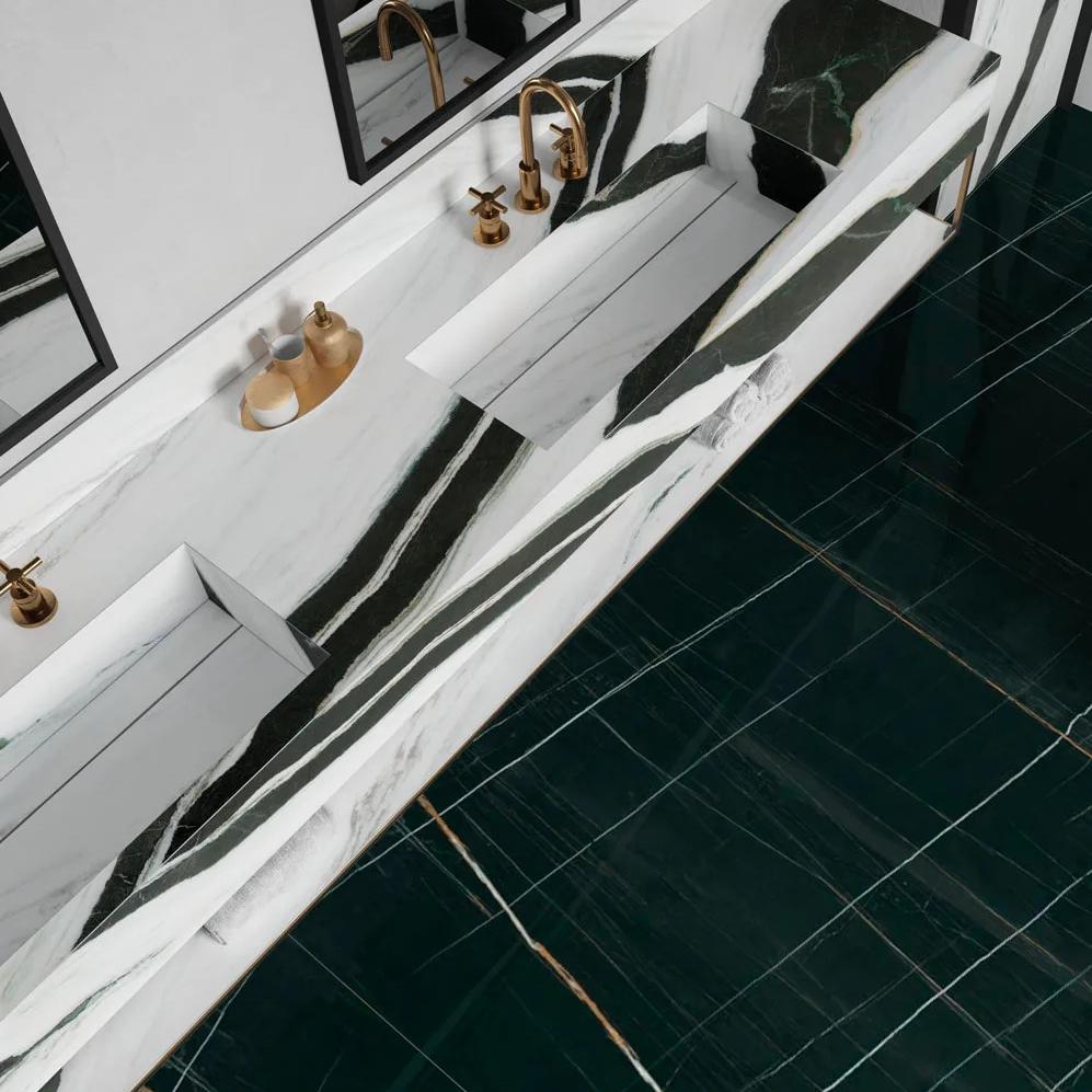 Modern bathroom with Sahara Noir porcelain slabs wall and white marble floating vanity shelf.