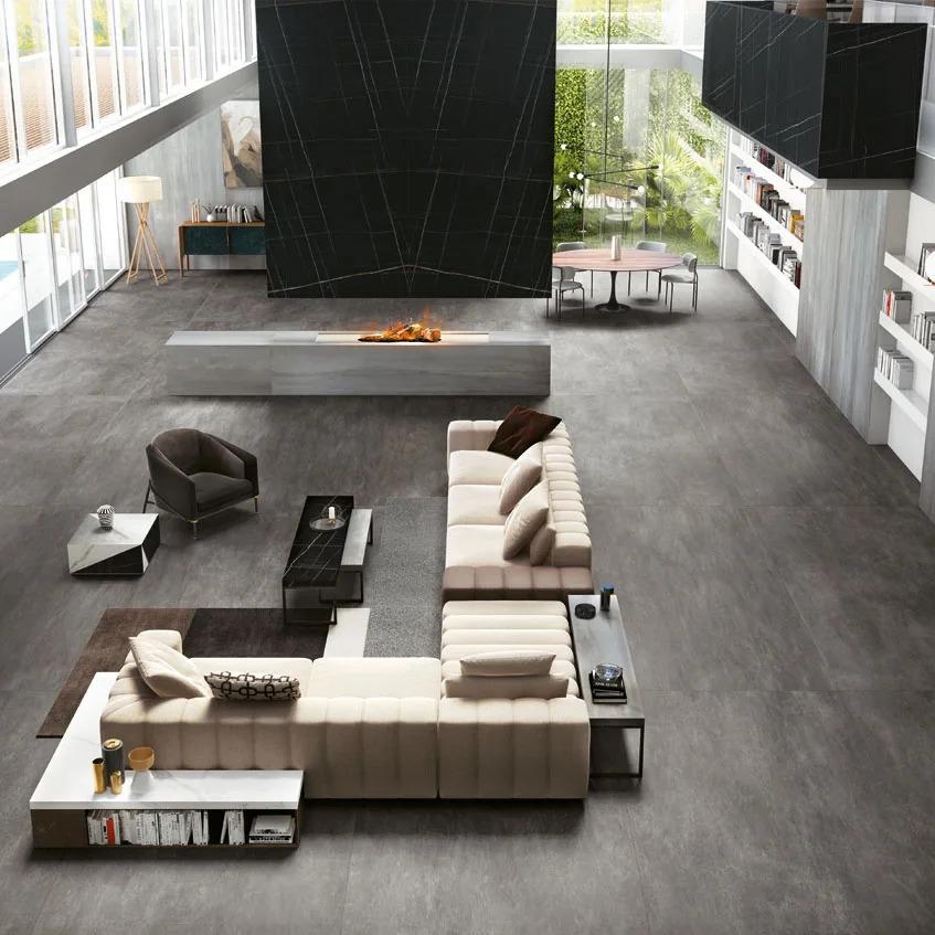 Contemporary open plan home with Sahara Noir porcelain slabs fireplace surround and grey floors.