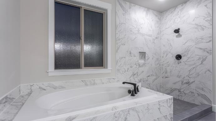 Summit 12x36 Matte Marble Look Ceramic Tile in a modern bathroom shower and tub surround.