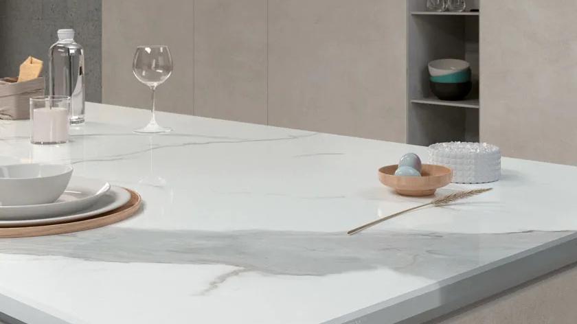 Dining table surface made from Classic Statuario porcelain slabs with elegant grey veining detail.