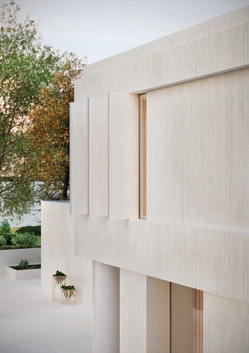 Travertino Bianco porcelain slabs used as exterior wall cladding on contemporary architectural home design.
