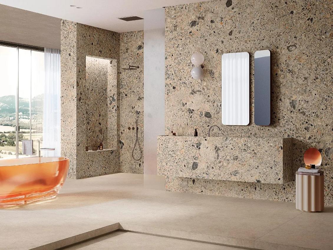 Ceppo Romano porcelain slabs covering full bathroom walls creating dramatic textured stone look interior design.