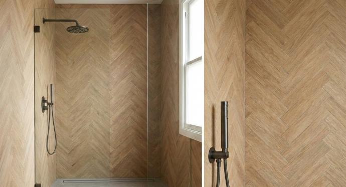 Wood look subway tiles with matte finish installed in modern shower with herringbone pattern