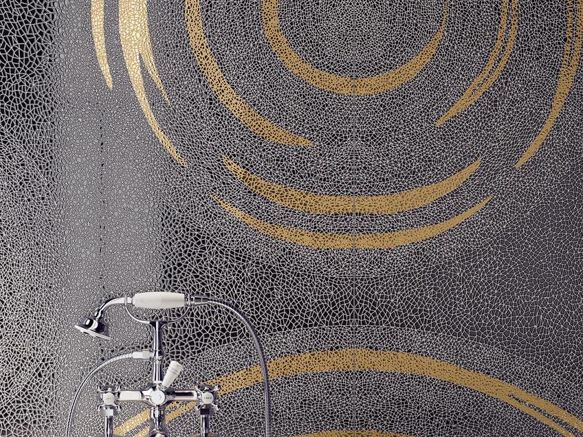 Holos Vik Black porcelain slabs with golden circular mosaic pattern on elegant wall.