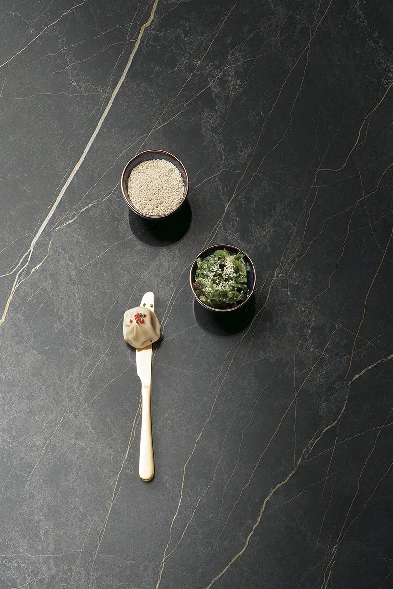 Royal porcelain slabs countertop with spice jars and silver spoon styled on surface.