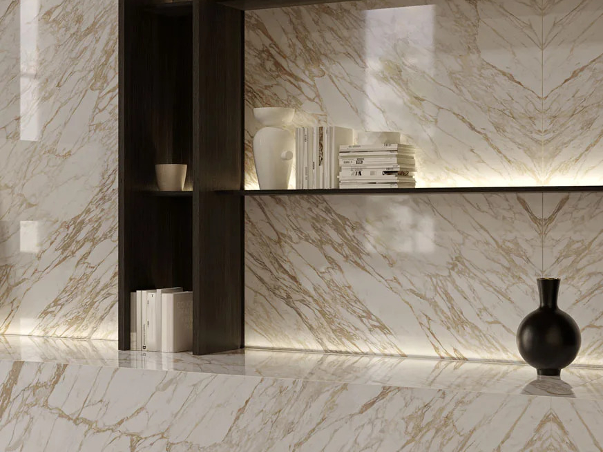 Arabescato Diva Porcelain Slabs feature countertop with elegant shelving and ambient lighting.