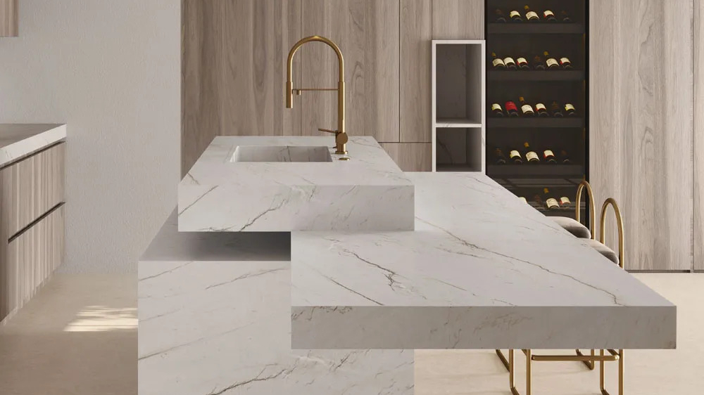 Minimalist kitchen showcasing Calacatta Brasile porcelain slabs on waterfall island and countertops.