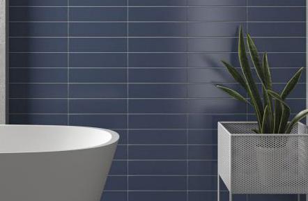 Modern interior featuring a wall of dark navy blue rectangular tiles (often called kit-kat or finger tiles) arranged in a horizontal stack pattern.