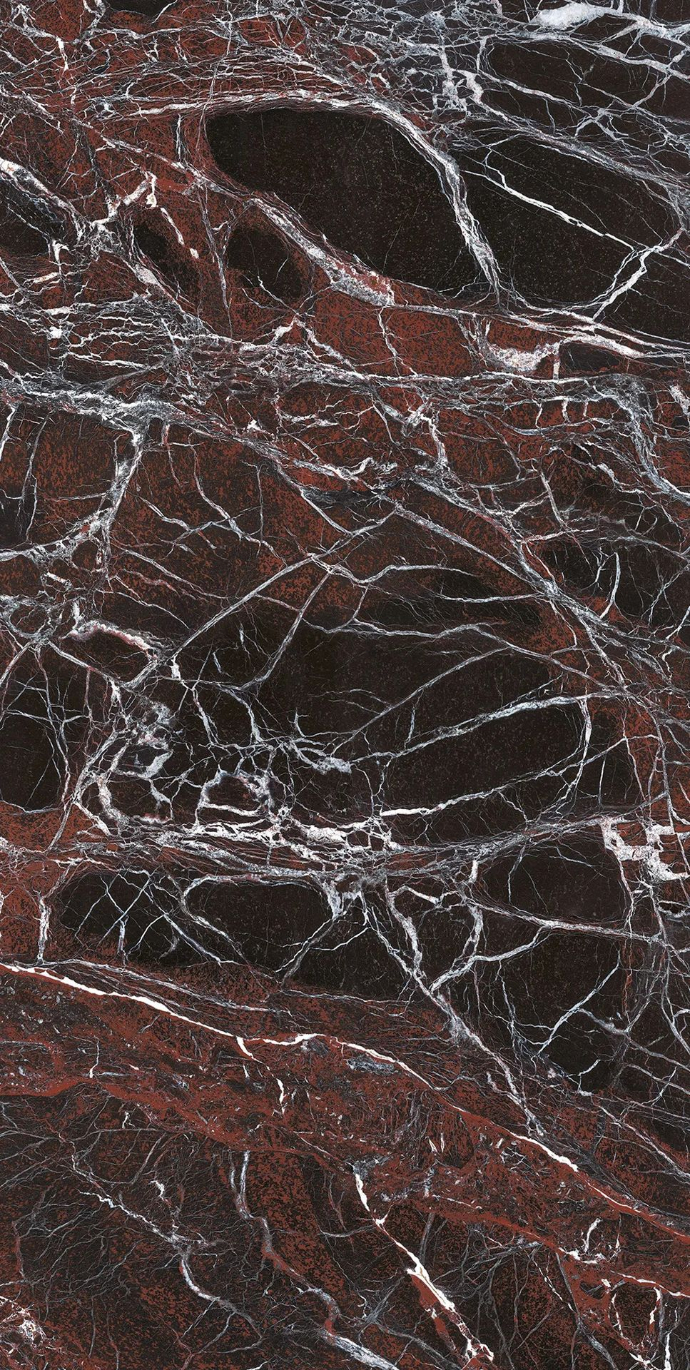 Close up view of Rosso Domus porcelain slabs showing red marble surface detail.
