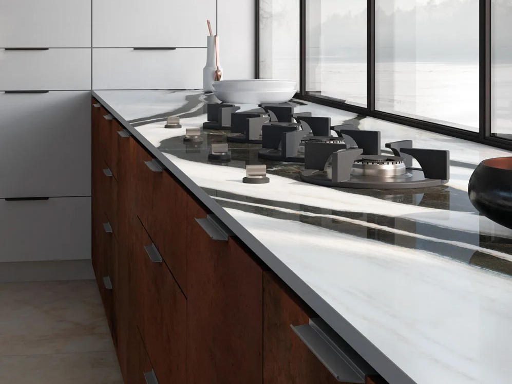 Modern kitchen featuring Panda White porcelain slabs countertop with dramatic black and white pattern.