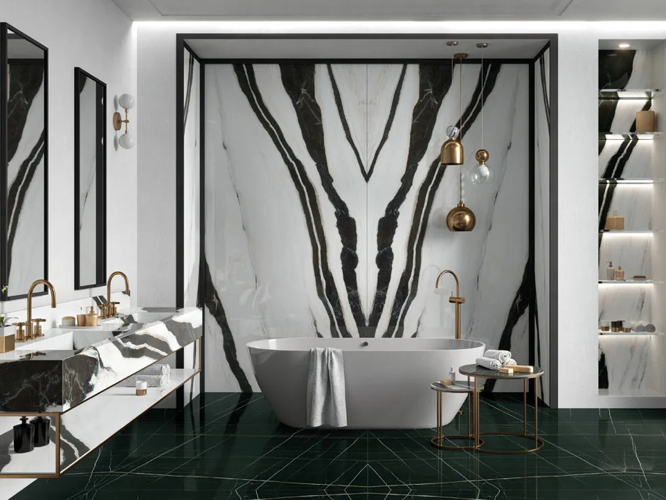 Panda White porcelain slabs bookmatched wall design in elegant bathroom with gold fixtures.