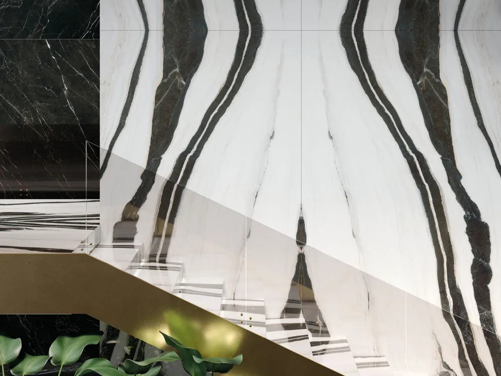 Interior stairway featuring Panda White porcelain slabs on walls with striking marble look.