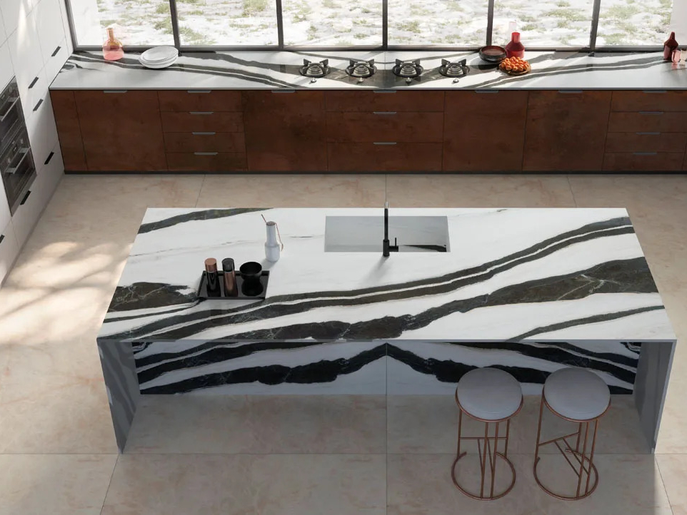 Large kitchen island made with Panda White porcelain slabs showing continuous veining pattern.