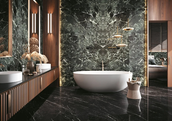 Spa bathroom showcasing Verde France Porcelain Slabs on feature wall behind freestanding tub.