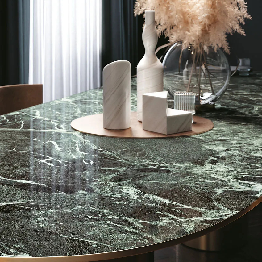 Verde France Porcelain Slabs used for round table with pampas grass and white vases.