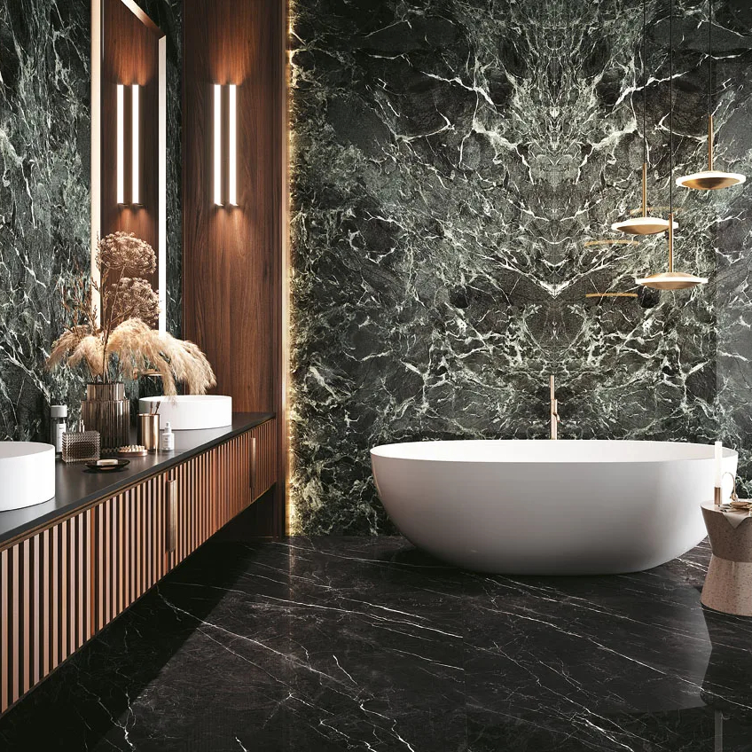 Luxury bathroom with Verde France Porcelain Slabs on walls and freestanding white bathtub.