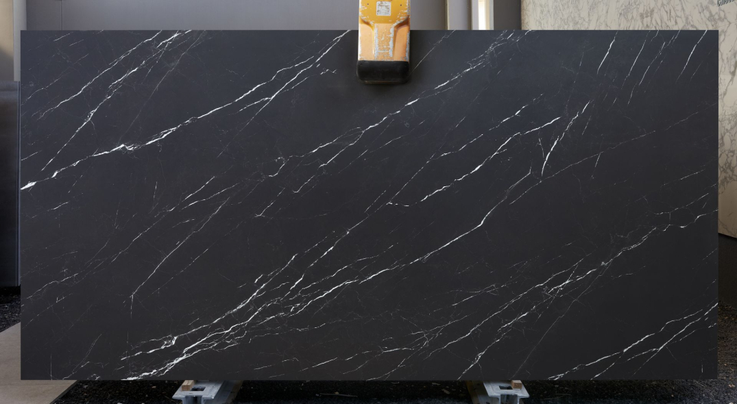 Nero Marquinia porcelain slabs displayed in showroom featuring deep black base with white veining.