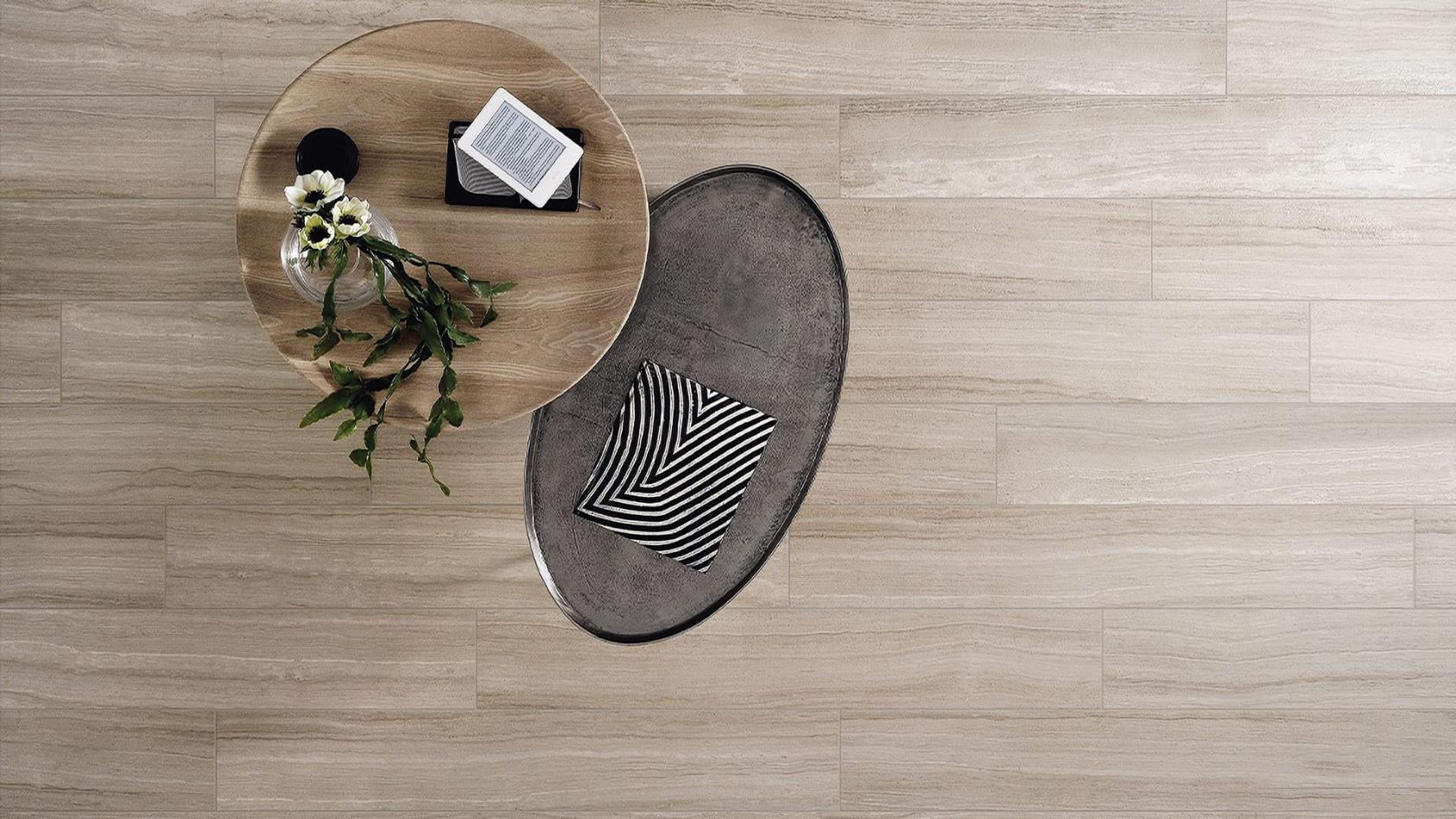 Top-down view of a living area featuring Torrent Travertine Look Porcelain Tile in taupe color.