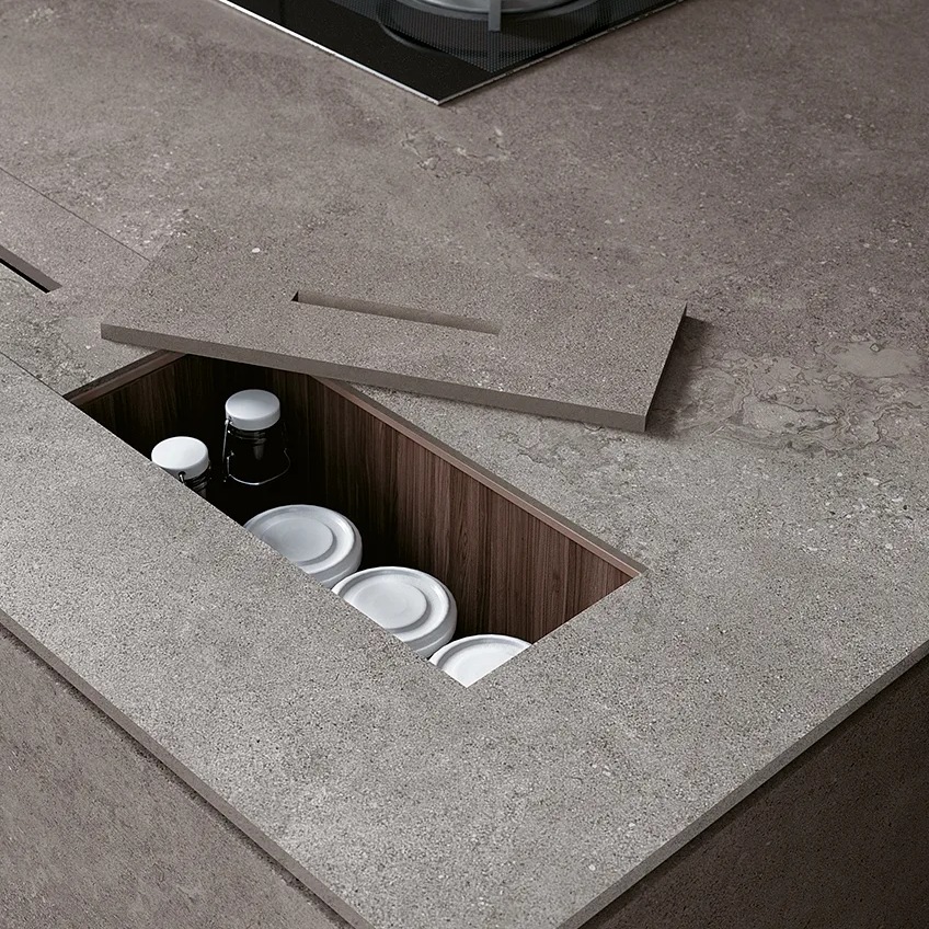 Countertop detail showing Buxy Select porcelain slabs with hidden storage compartment for dishes and plates.